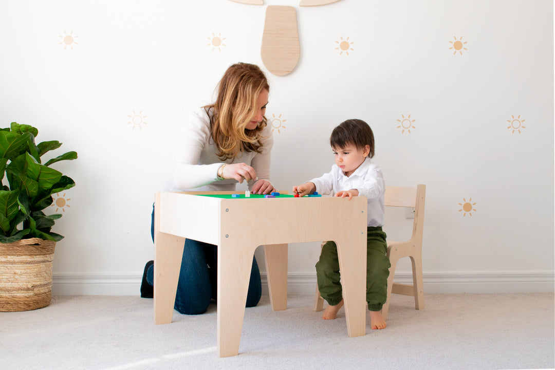 Mother Playing With Her Child On A Toddler Desk And Chair