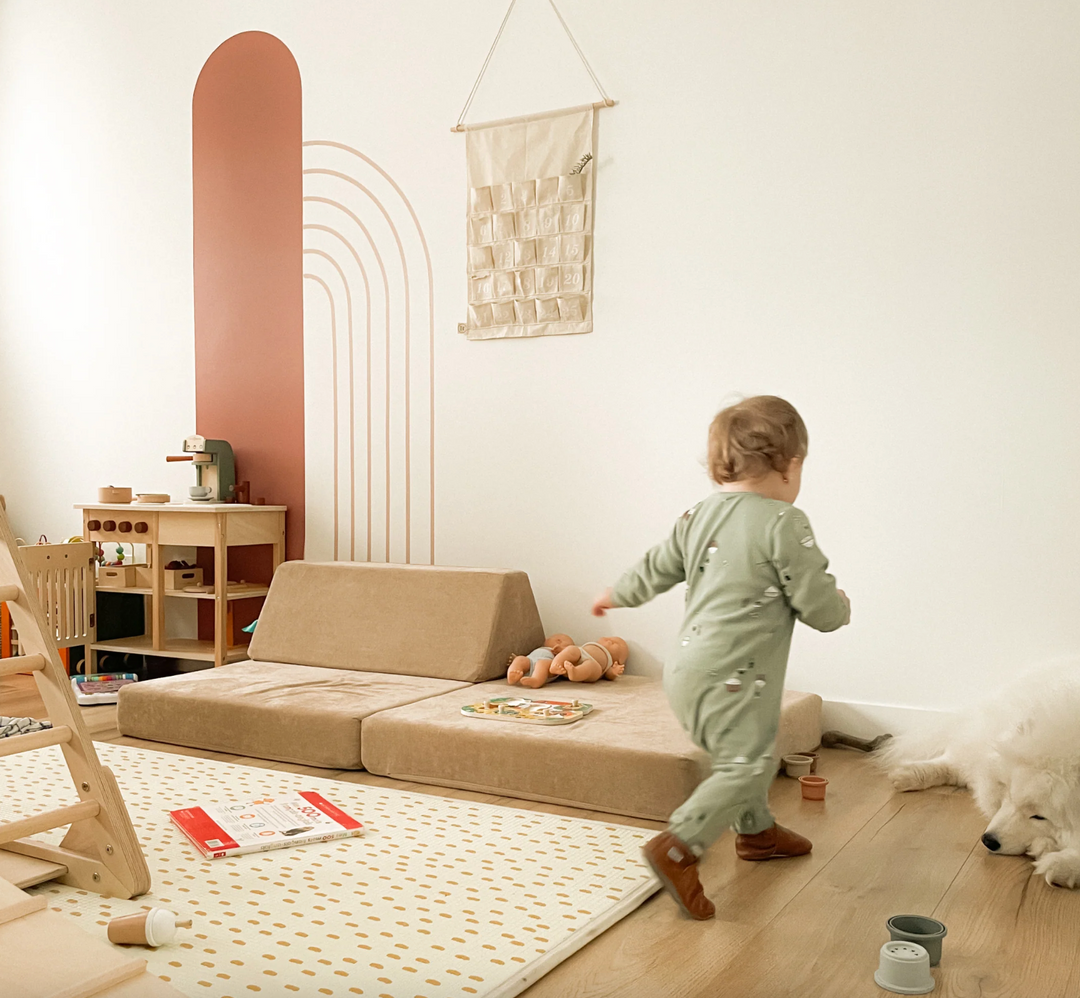 Toddler playing with a brown modular play couch