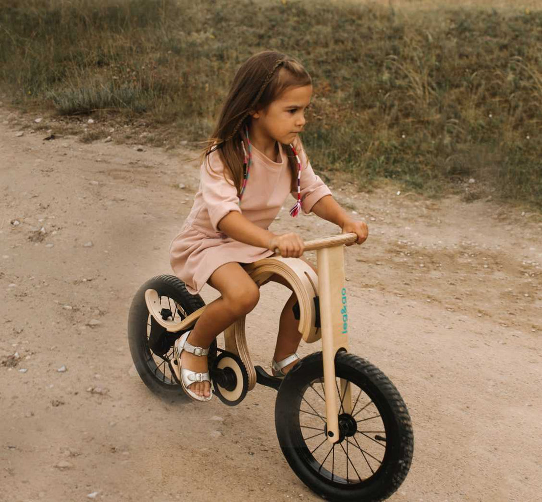 Girl Riding a Transformable Wooden Balance Bike